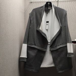 Women’s jacket,gray and white with removable bottom  and removable sleeves .